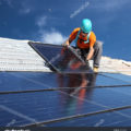 stock-photo-installing-alternative-energy-photovoltaic-solar-panels-on-roof-123739609